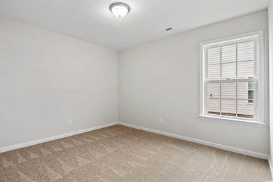 Unfurnished room with carpet flooring