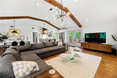 Living area featuring recessed lighting, a chandelier, wood finished floors, and french doors