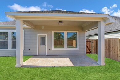 Covered back patio is perfect for outdoor relaxati