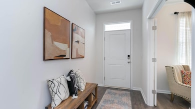 Virtually staged Entryway featuring wood finished floors and baseboards