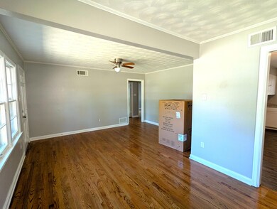 Unfurnished room featuring visible vents, a ceilin