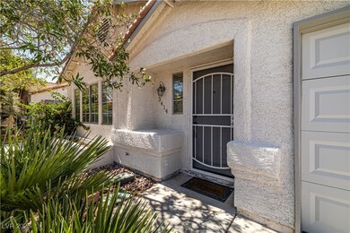 View of exterior entry with stucco siding, a garag