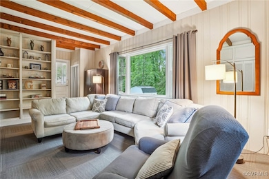 Living room featuring beamed ceiling