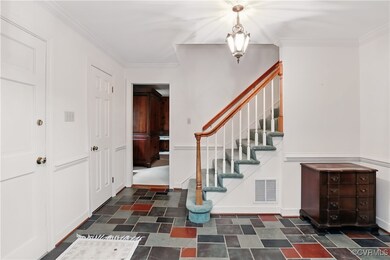 Entrance foyer featuring stairway, ornamental mold