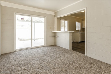 Unfurnished living room with a sink, concrete bloc