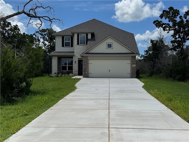 View of front of home with driveway, a shingled ro