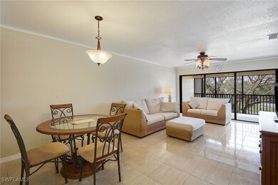 Tiled dining room featuring crown molding, ceiling