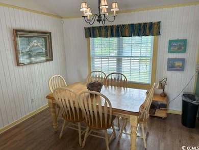 Dining area with hardwood / wood-style flooring an