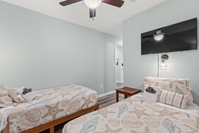 Bedroom featuring ceiling fan and hardwood / wood-