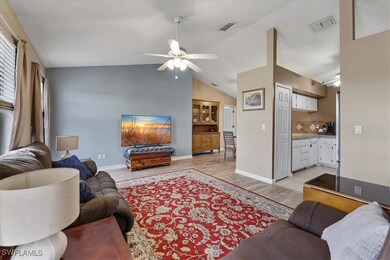 Living room featuring a ceiling fan, lofted ceilin