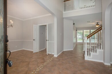 Once inside, you see the ceramic tile detailing on the floor that creates quiet separation of the entry, formal dining and living room spaces!  Fresh paint throughout this home makes it move in ready!