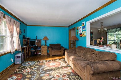Living room with large picture window and hardwood
