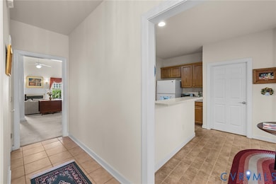 Corridor featuring recessed lighting, light carpet, and light tile patterned flooring