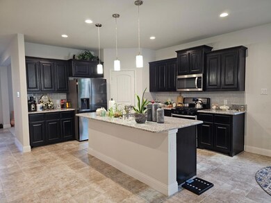 Kitchen featuring light tile patterned flooring, a