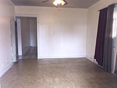 Living room has gas heater and window unit.