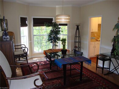 Formal dining with Hardwood floors and Bay window.