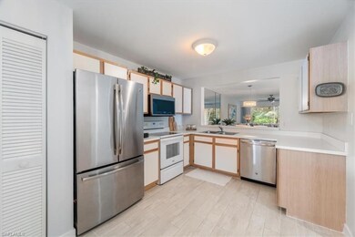 Kitchen featuring stainless steel appliances, light countertops, light wood-type flooring, and light brown cabinets