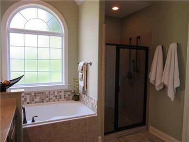 Master bath also has large separate tiled shower.