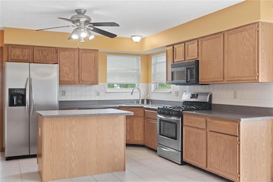 Kitchen w/ corner sink, central island & stainless