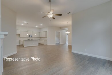 Unfurnished living room with light hardwood / wood-style flooring and ceiling fan with notable chandelier
