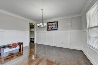 Unfurnished dining area featuring a decorative wal