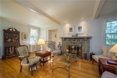 The spacious living room offers gleaming hardwood 