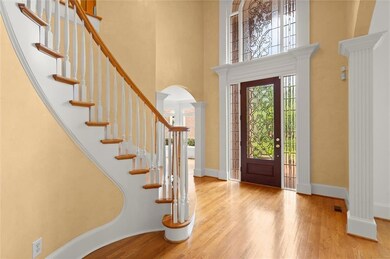 Foyer with a towering ceiling, arched walkways, wo