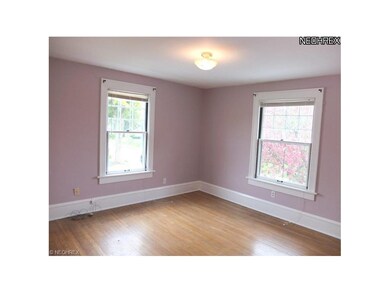 Master bedroom with hardwood floors.