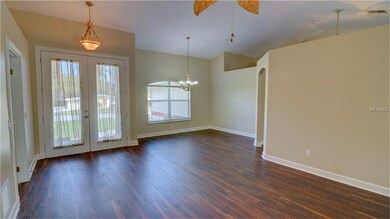 Living room looking back at front doors and into d