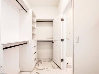 Spacious closet with light marble finish flooring