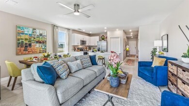 Living room featuring ceiling fan and light wood-t