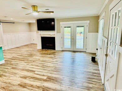 Unfurnished living room with french doors, crown m