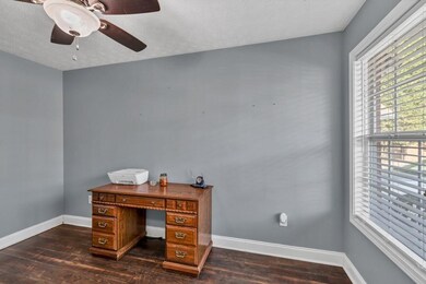 Office featuring a textured ceiling, a ceiling fan