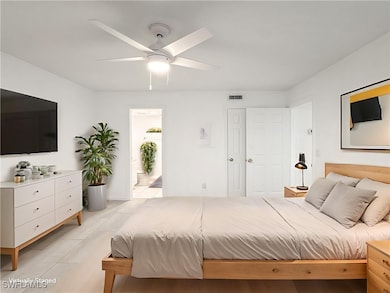 Bedroom featuring a ceiling fan and connected bathroom