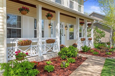 Gorgeous front porch enhanced by lush landscaping!