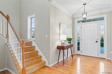 Foyer with ornamental molding, plenty of natural l