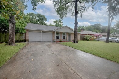 A view along the other side of the home to the two car garage. The driveway provides terrific additional parking for your guests when entertaining.