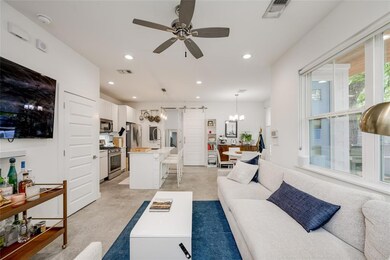 Living room featuring ceiling fan with notable ch