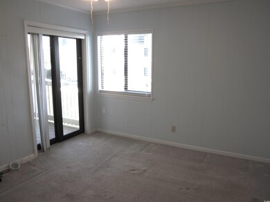Empty room with carpet floors, ornamental molding,