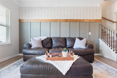 Living room with ornamental molding, wood finished