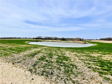 View of home's community with a water view and a lawn