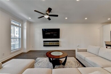 Living area with crown molding, recessed lighting, dark wood finished floors, and a ceiling fan