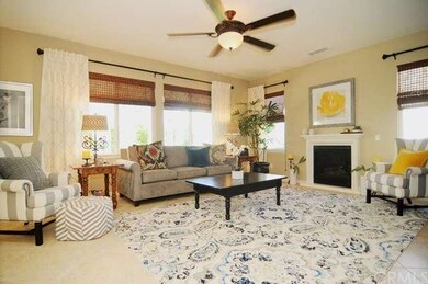 Spacious family room with neutral tile flooring an