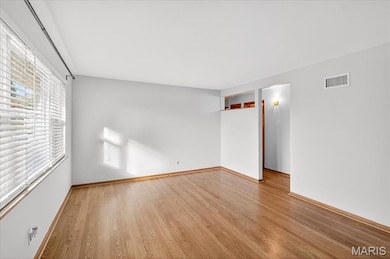 Empty room with wood finished floors and baseboards