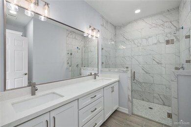 Full bathroom with a marble finish shower, wood tiled floors, and recessed lighting