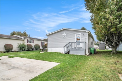 Back of house with a yard and a wooden deck