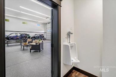 Bathroom featuring light aggregate flooring and baseboards