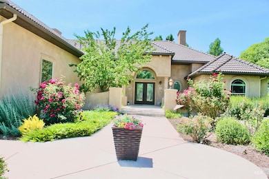 Doorway to property with french doors, stucco siding, a chimney, and a tiled roof