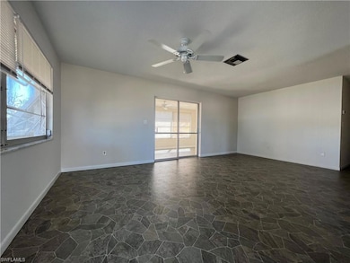 Living room with ceiling fan, vinyl floors, and a 
