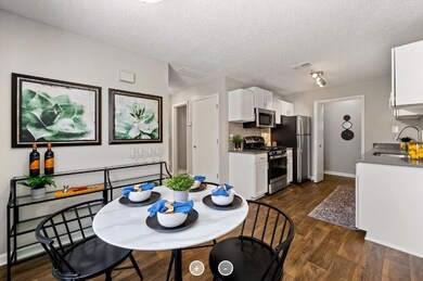 Dining area featuring rail lighting, sink, a textu